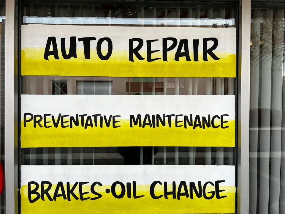 Automobile services sign on a window 